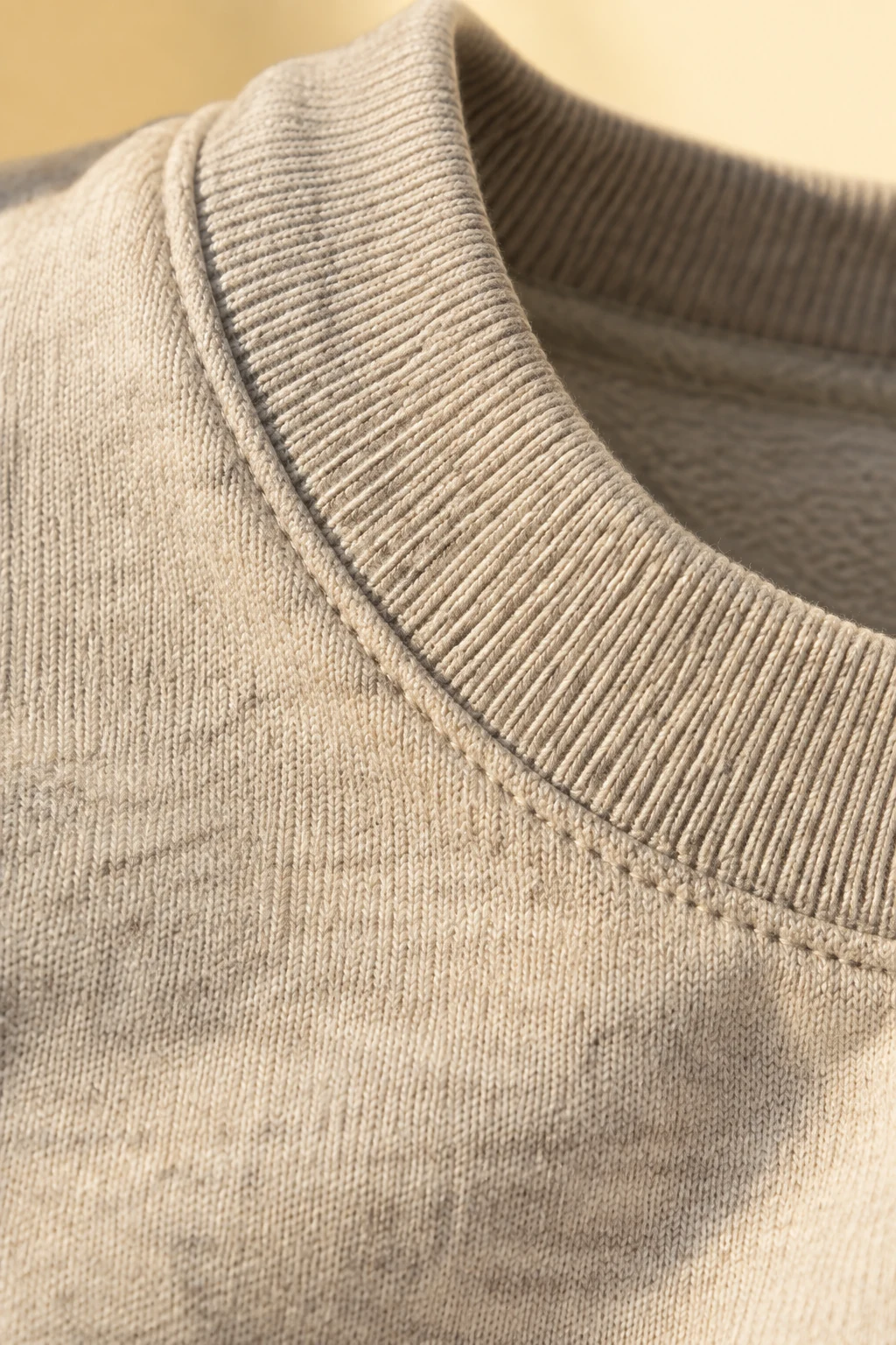 Close-up of heavyweight oat cotton jersey and a ribbed collar